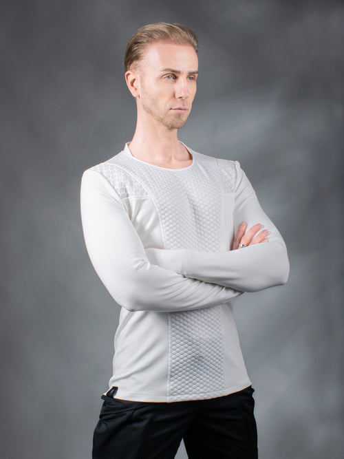 Man in white futuristic pullover with textured shoulder panels, arms crossed, solarpunk – ZOLNAR