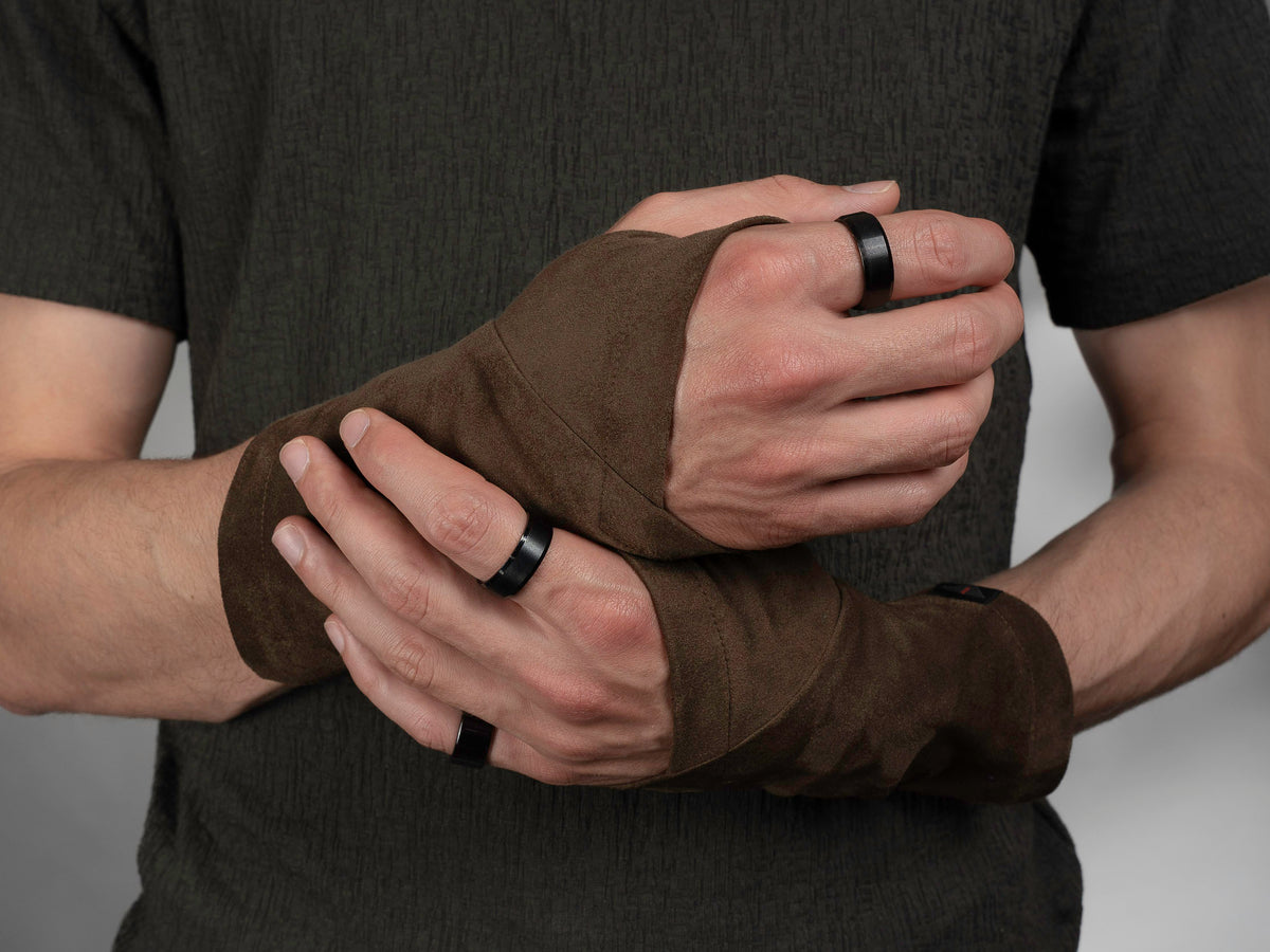 Brown faux suede arm warmers with thumbhole, hands clasped, close-up – ZOLNAR