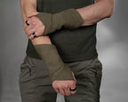 Man in olive trousers wearing khaki faux suede fingerless gloves, arms crossed – ZOLNAR