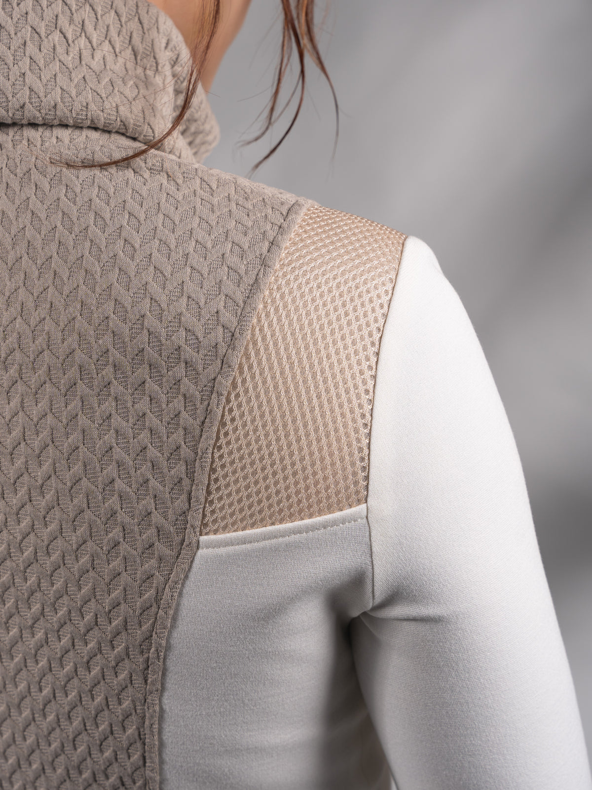 Close-up of beige cable-textured turtleneck collar and back panel – ZOLNAR