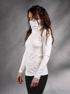 Side view of white asymmetric sweater with high collar pulled up over the face – ZOLNAR