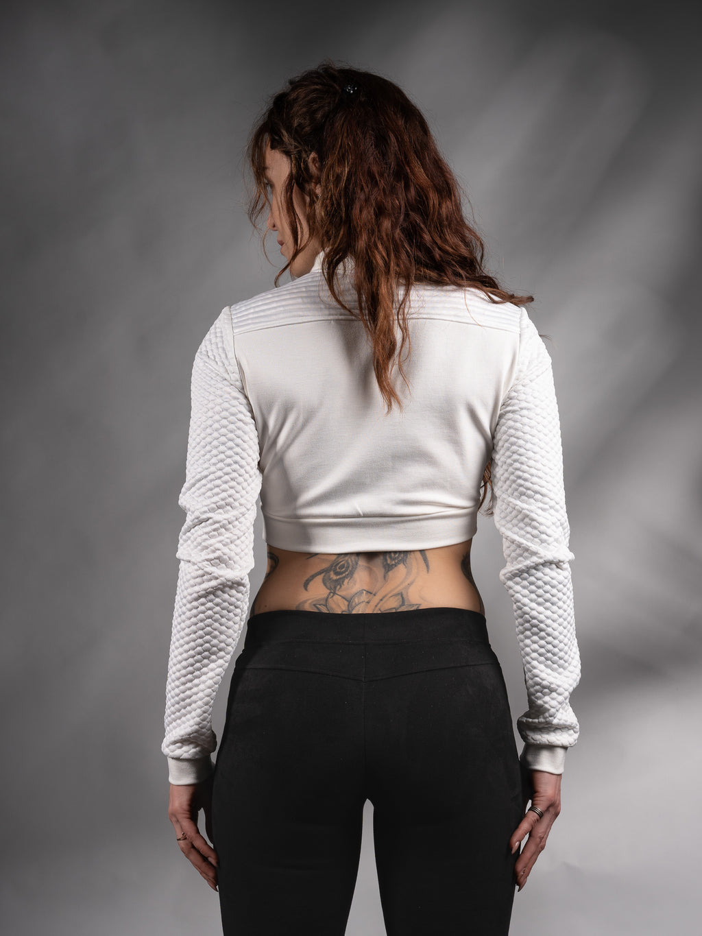 Back view of white cropped sweater with textured sleeves – ZOLNAR